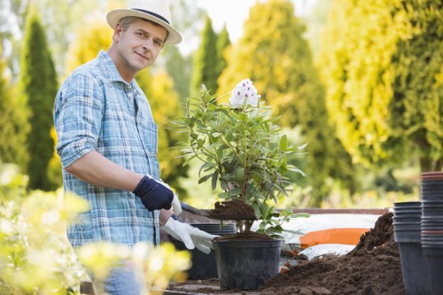 Trained gardeners applying health and safety standards in garden maintenance